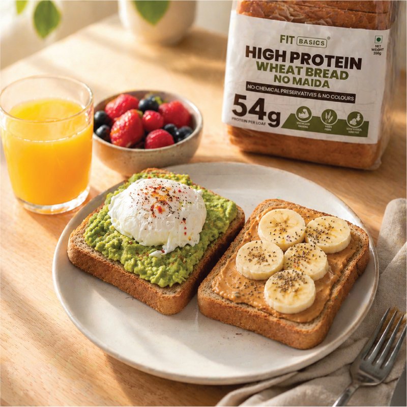 Top-down flat lay of whole-grain toast with avocado and micro-greens on artisanal ceramic